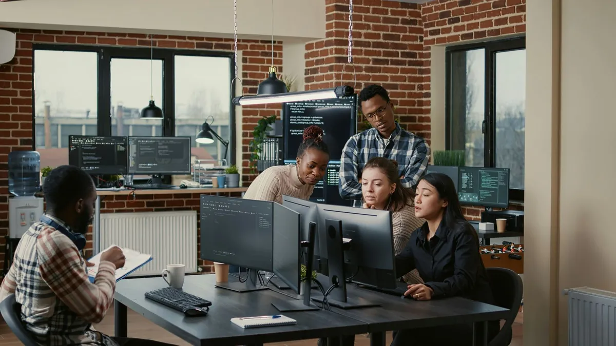 Software developer working with code on screen
