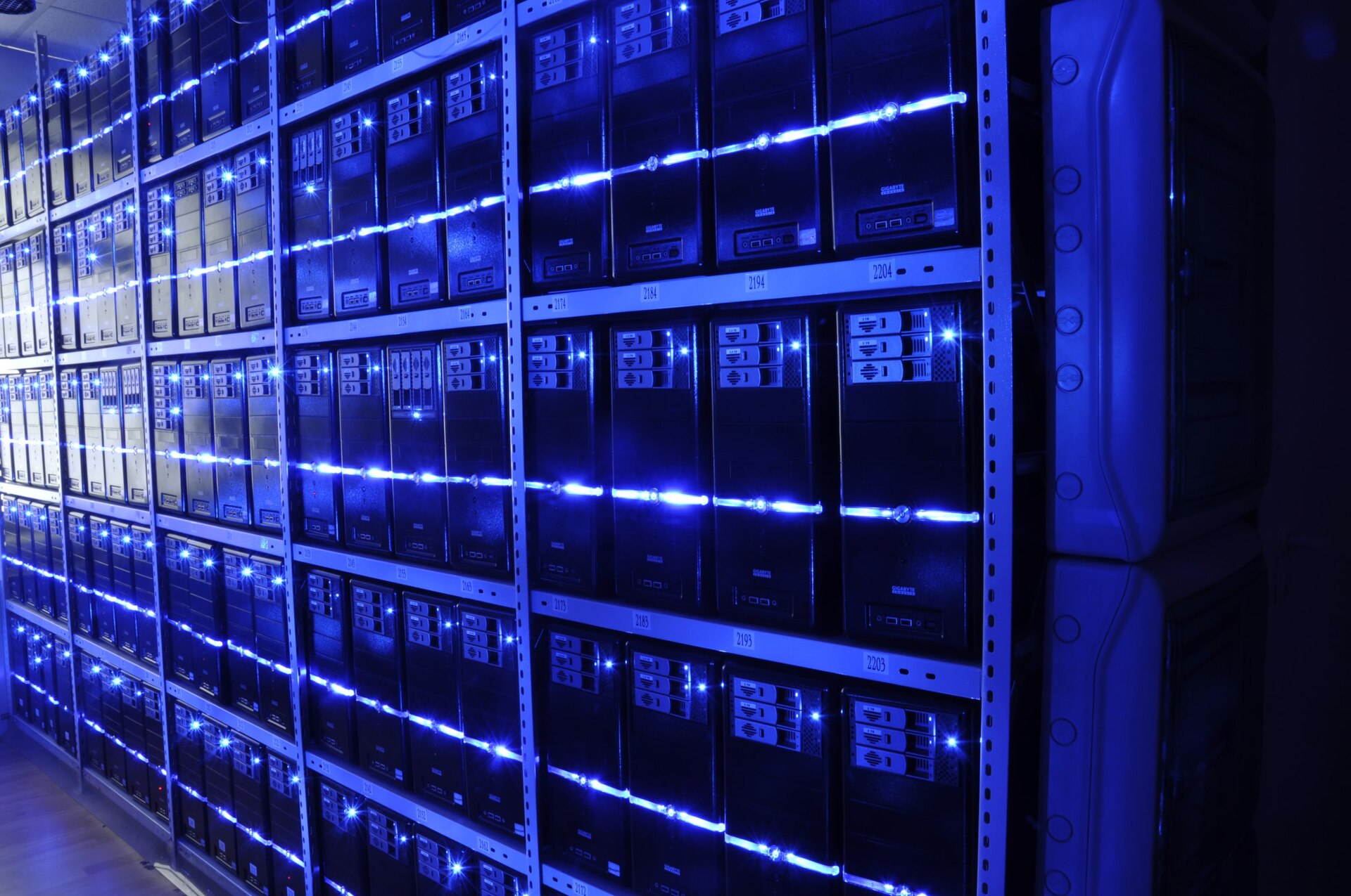 Rows of blue-lit server racks in a data center