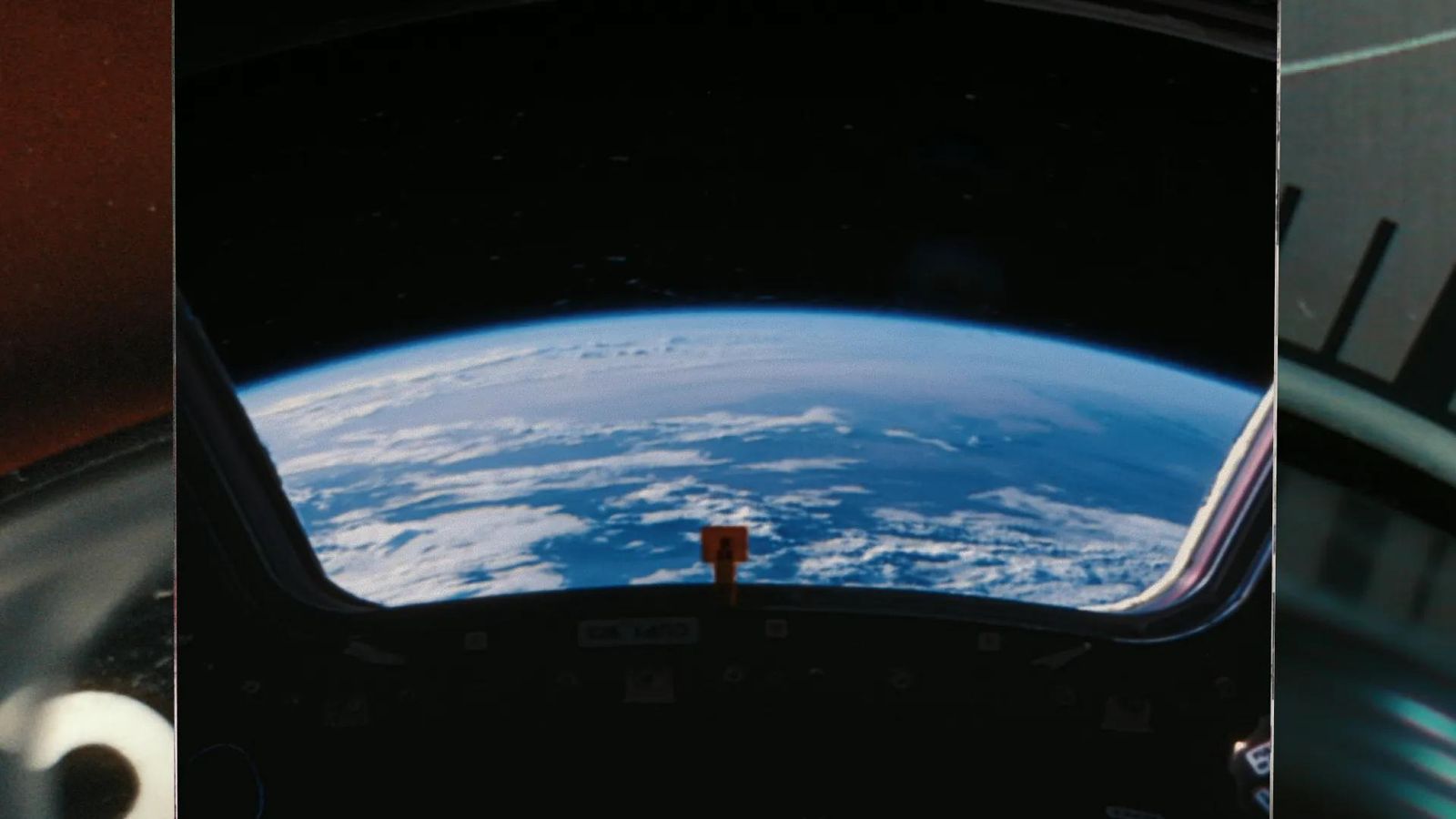 Cinematic still of Earth viewed from a spacecraft window, from Anthropic's brand film