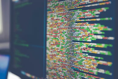 Close-up of colorized source code on a computer monitor