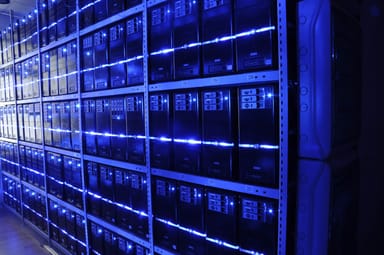 Rows of blue-lit server racks in a data center