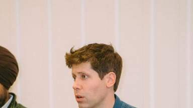 OpenAI CEO Sam Altman speaking at an event, cropped to landscape